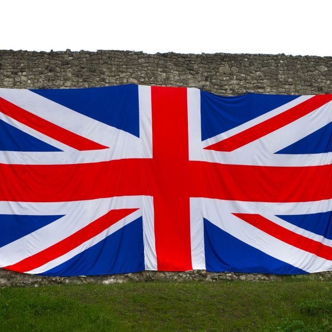 Union Jack flag draped over a historic stone wall, symbolizing British heritage in Rochester, England.