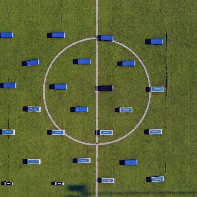 Top-down view of football field setup with benches. Abuja, Nigeria.
