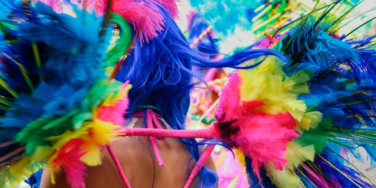 a woman wearing a colorful headdress in a parade