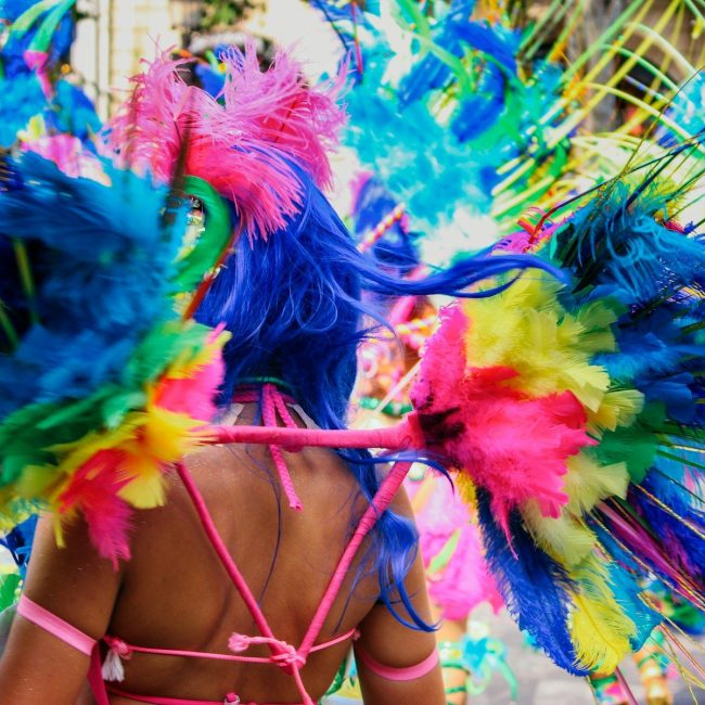 a woman wearing a colorful headdress in a parade