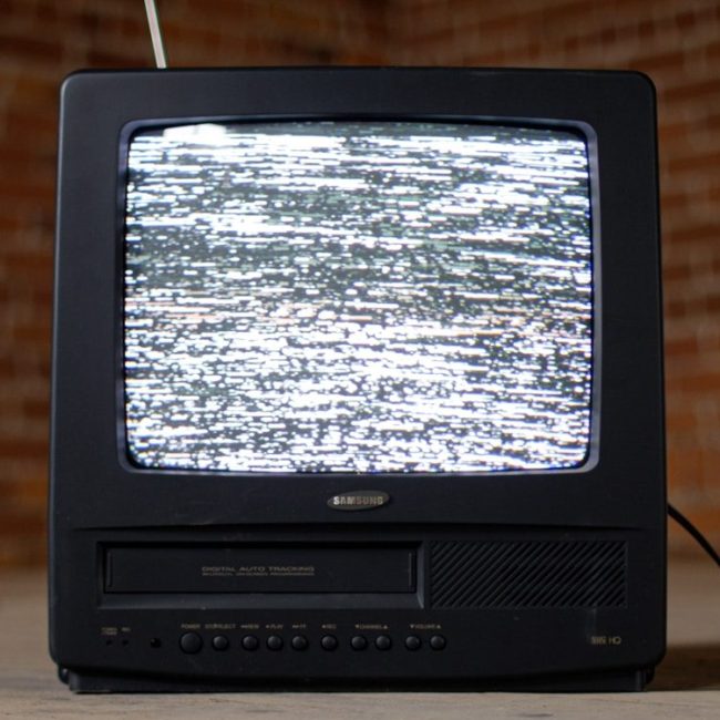 black crt tv on brown wooden table